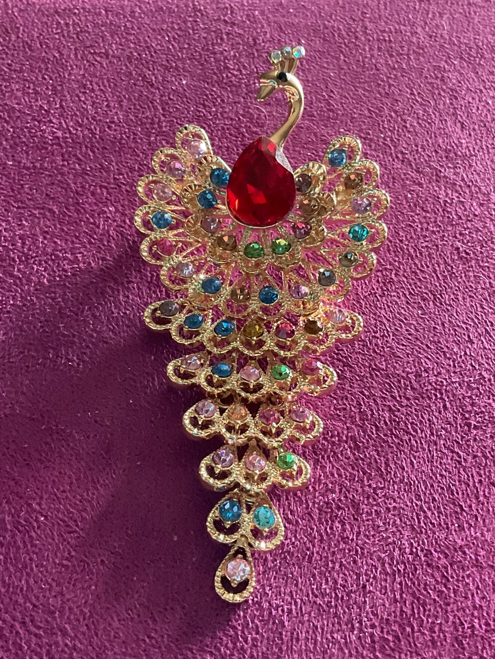 Elegant Gold-Tone Peacock Brooch with Red and Multicolor Crystals  4 1/4” long.